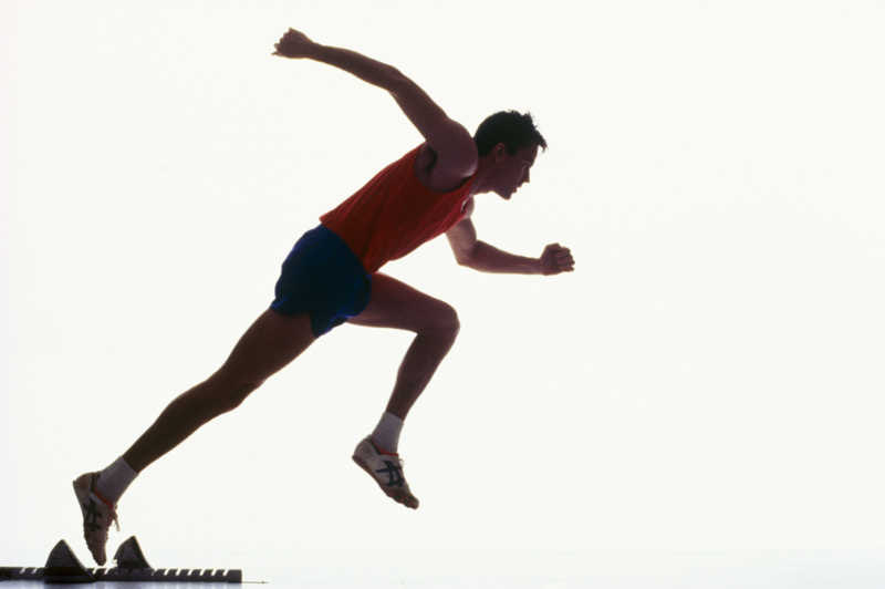 Track runner leaving starting blocks, hitting his stride photo